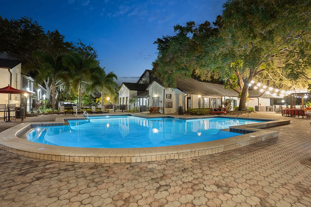 Community Swimming Pool with Pool Furniture at Carrollwood Station Apartments in Tampa, FL.