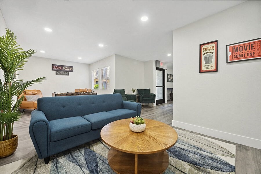 Community Clubhouse with Lounge Furniture and Game Tables at Villages at Metro Center Apartment located in Phoenix, AZ.