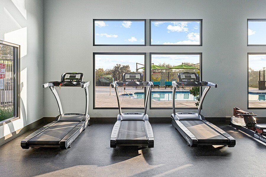 Community Fitness Center with Equipment at Santa Fe Ranch Apartments located in Carlsbad, CA.