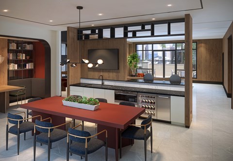A modern kitchen with a long table and chairs.