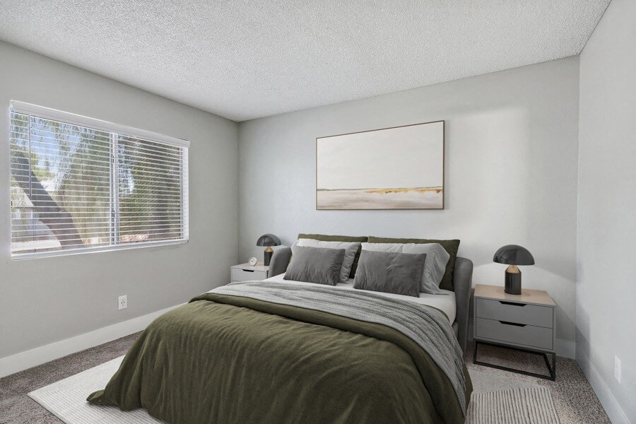 an empty bedroom with a bed and a window