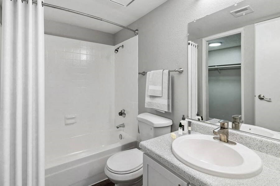 a white bathroom with a sink and a toilet