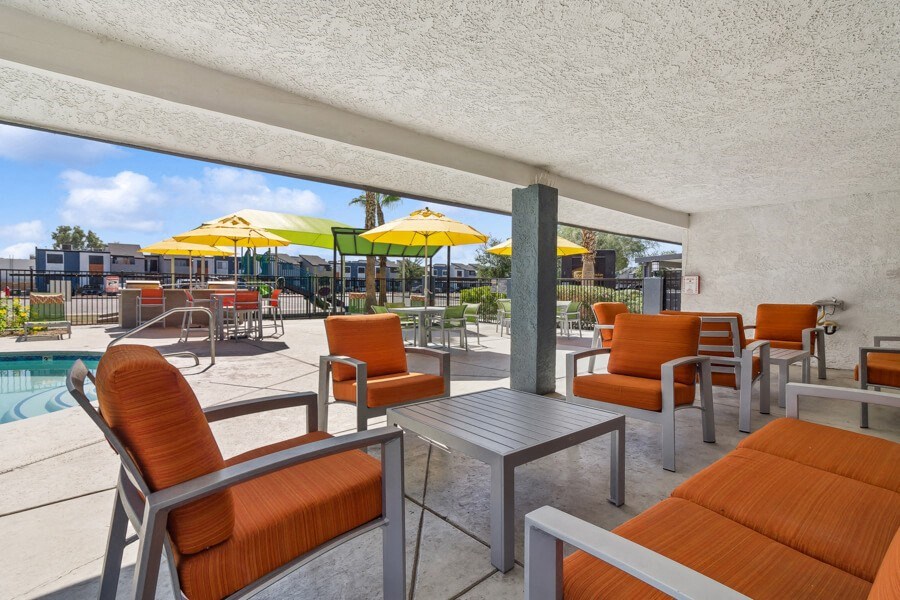 our apartments have a large patio with tables and chairs and a pool