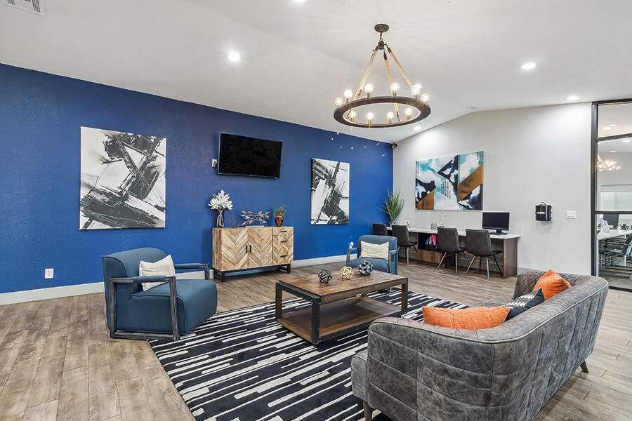 a living room with a blue wall and a couch and a table