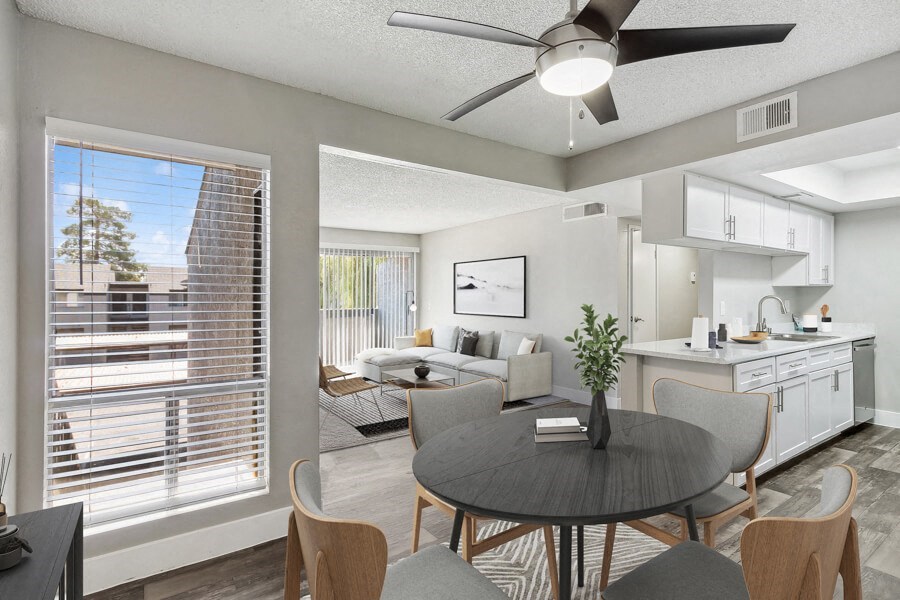 an open living room with a dining room table and a kitchen