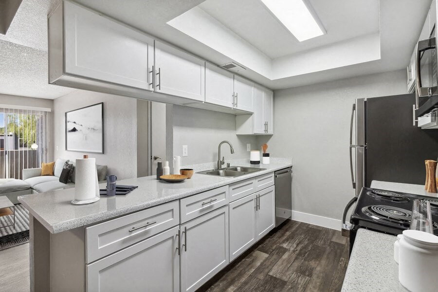 a kitchen with white cabinets and stainless steel appliances