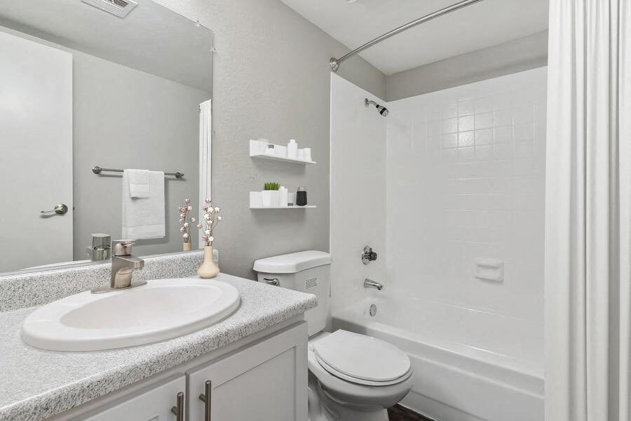 a white bathroom with a sink and a toilet