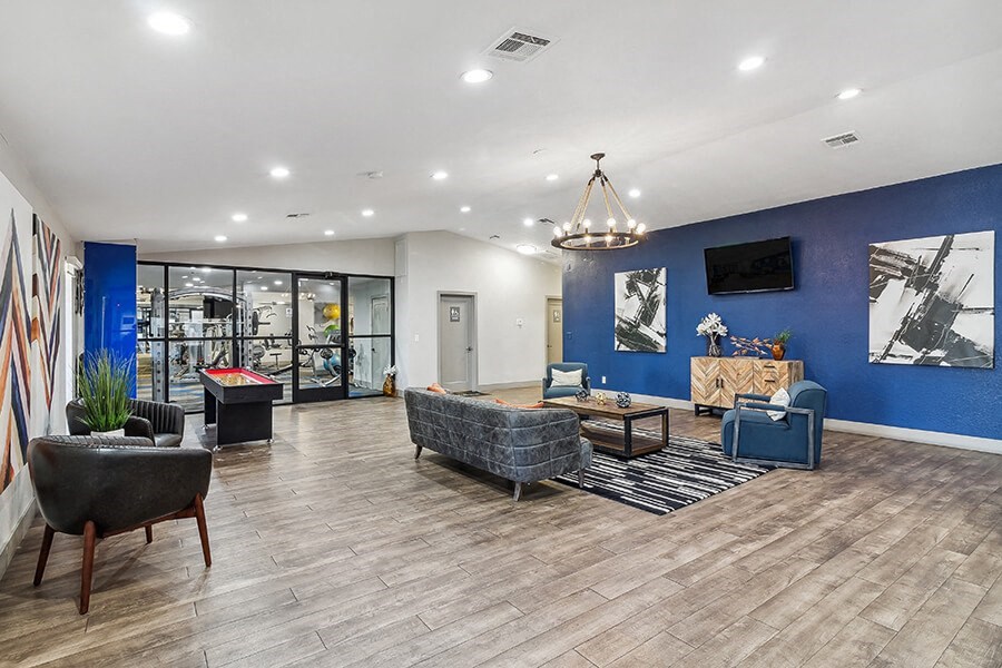 a lobby with couches and chairs and a tv