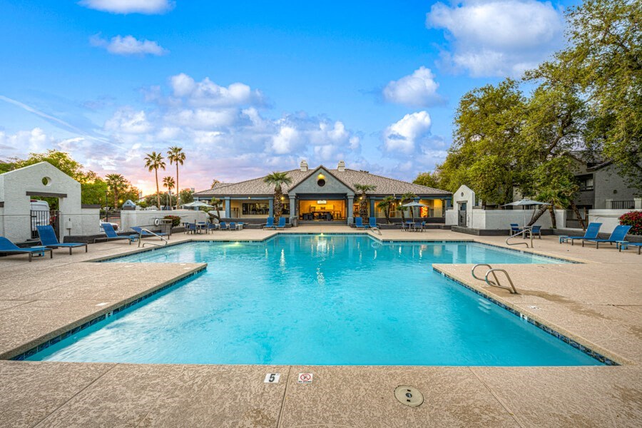 a swimming pool with a building in the background at Array South Mountain, Phoenix, AZ, 85044