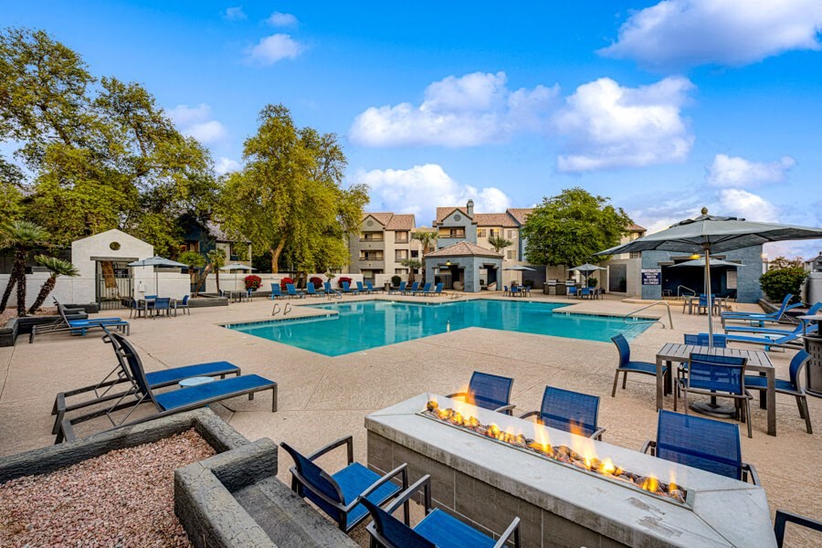 a swimming pool with chairs and a fire pit at Array South Mountain, Phoenix, 85044