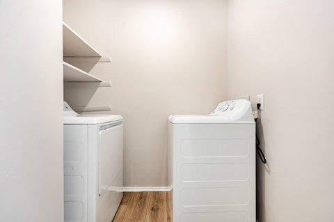 A white washing machine and dryer in a small laundry room.