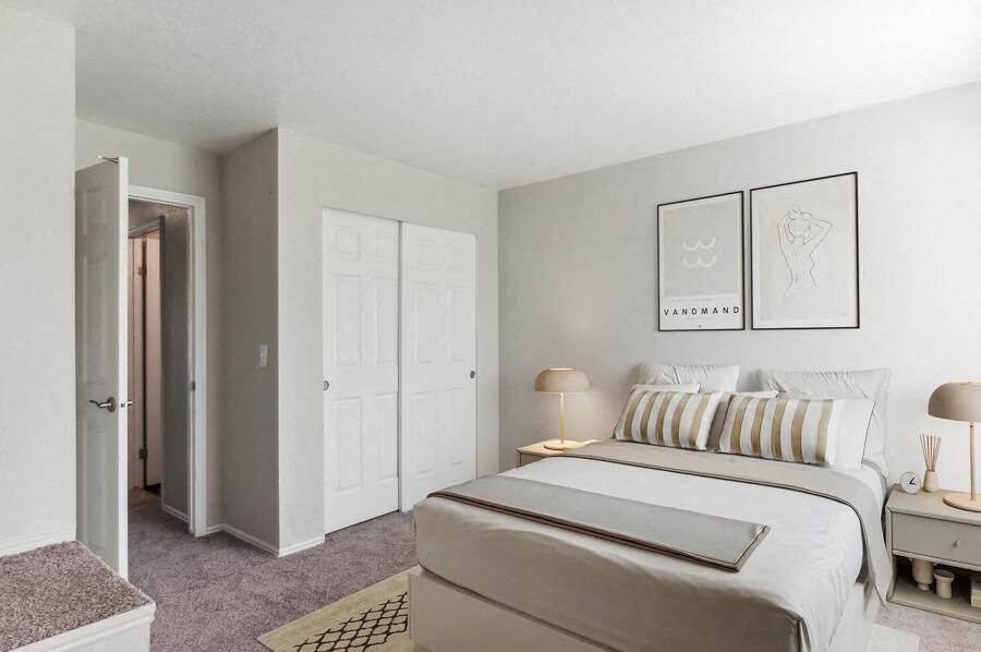 a bedroom with a bed and two night stands