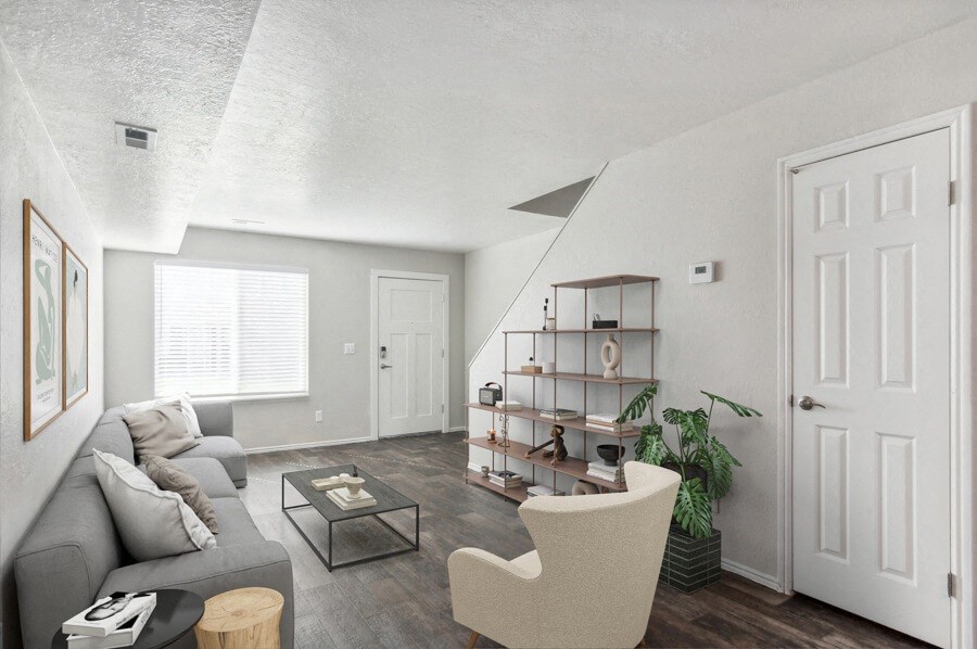 Model living room with a grey couch and a coffee table