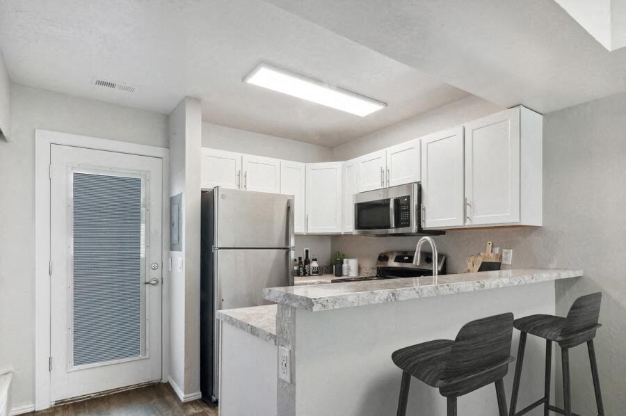 a kitchen with a counter top and a refrigerator