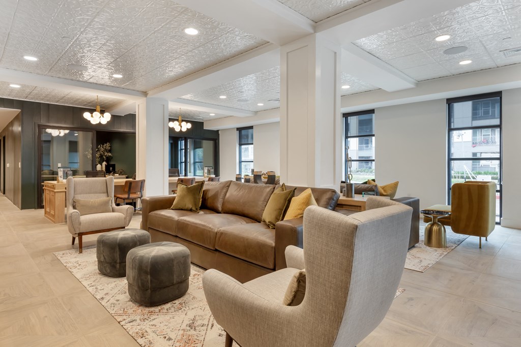 a large living room with couches and chairs and a table