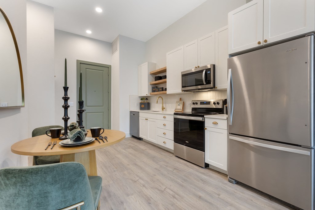 a kitchen with stainless steel appliances and a stainless steel refrigerator