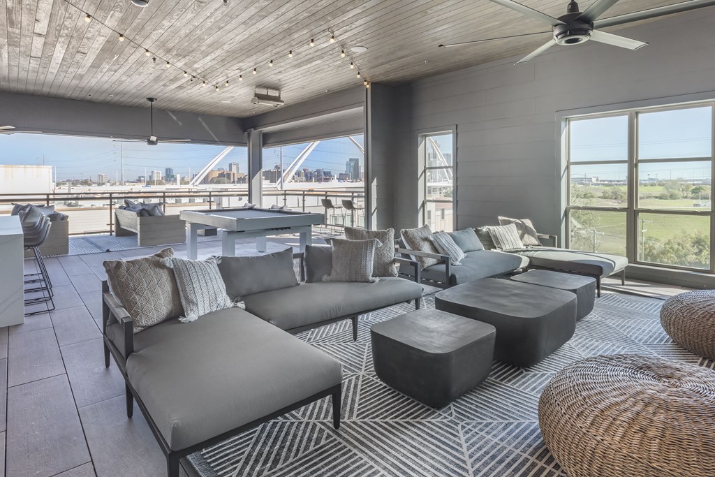 a living room with couches and a table and a view of a bridge