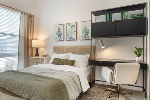 Luxury Studio Apartments Bishop Arts District, TX - Banyan Flats - Bright Studio Bedroom With Large Windows, Neutral Bedding, Modern Desk Nook, And Built In Shelving