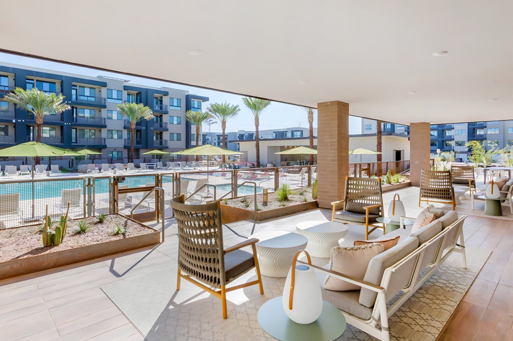 a lobby with a pool and chairs and tables