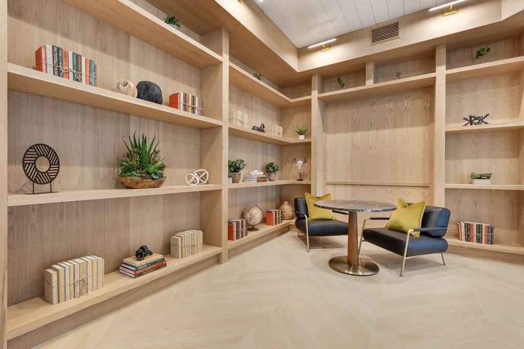 library with a table and chairs in it