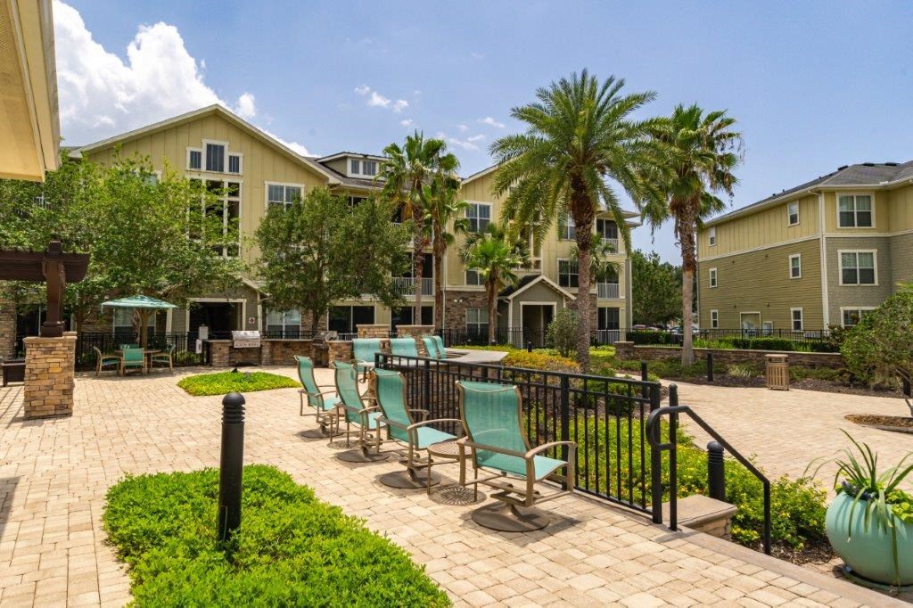 Apartment exterior with lush landscaping at Bridges at Crosstown in Tampa, FL