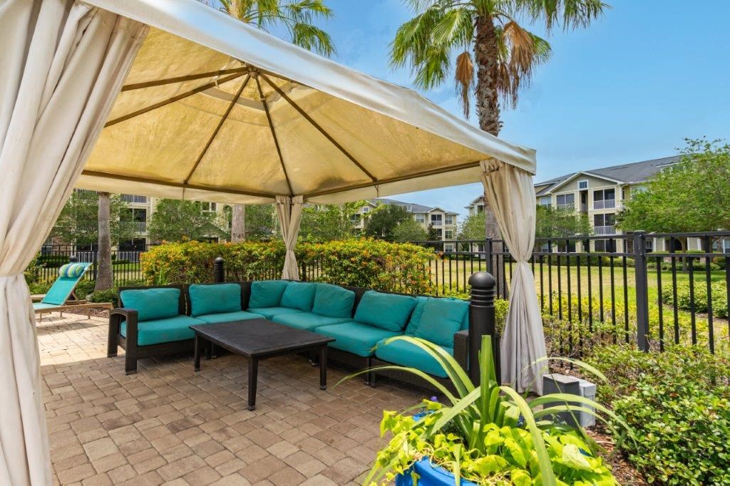 A patio with a canopy and a bench at Bridges at Crosstown in Tampa, FL