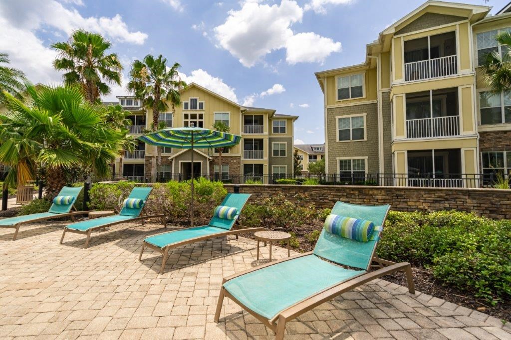 Loungers surrounding pool at Bridges at Crosstown in Tampa, FL