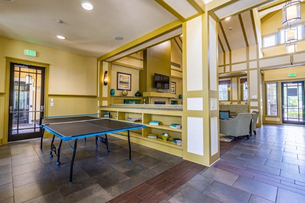 A room with a ping pong table and a TV  at Bridges at Crosstown in Tampa, FL