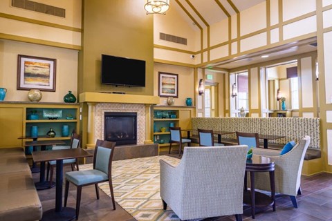 A living room with a fireplace and a television on the wall.