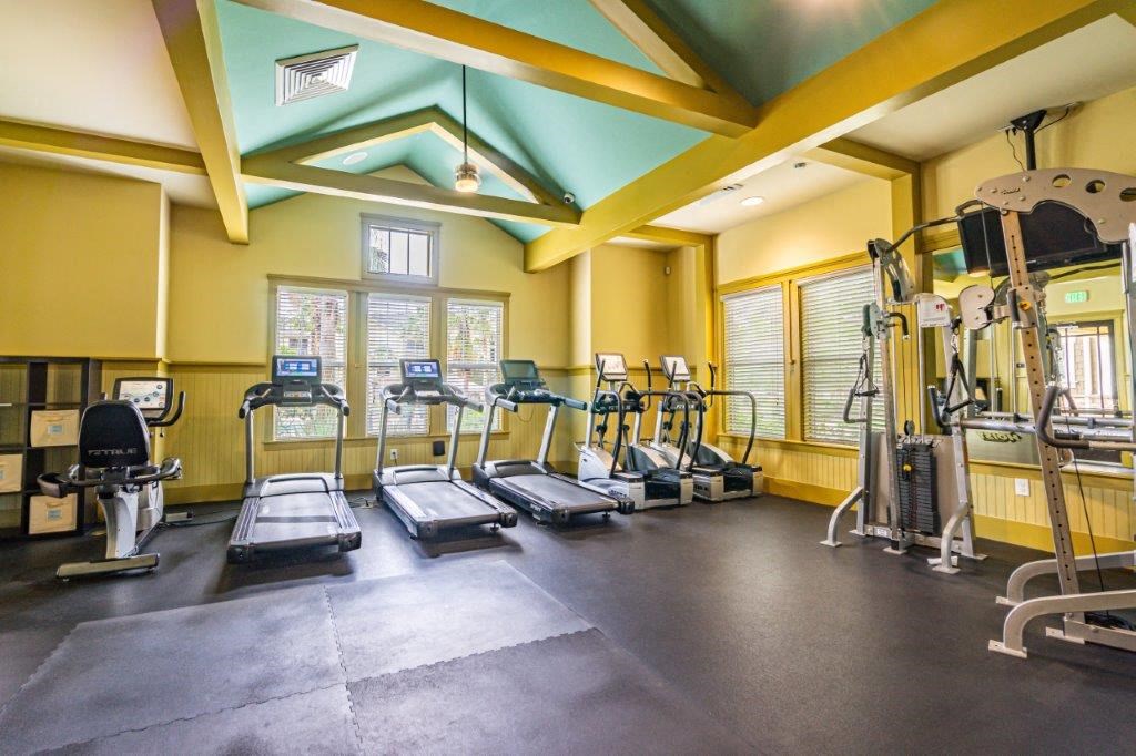Fitness center with treadmills, elliptical machines, and other exercise equipment at Bridges at Crosstown in Tampa, FL