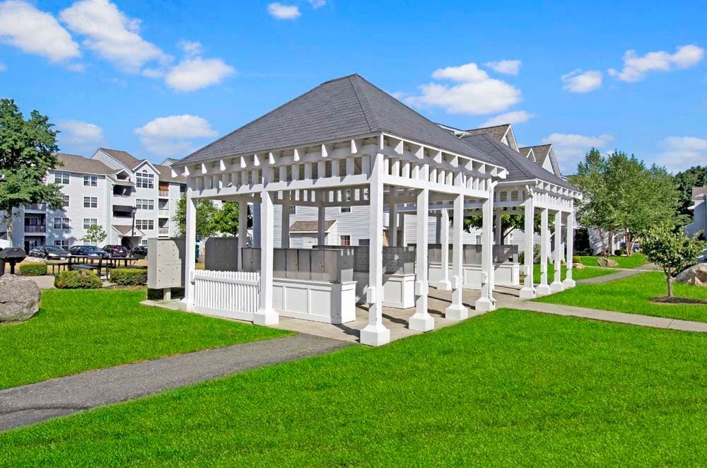 a large white gazebo in the middle of a grassy area