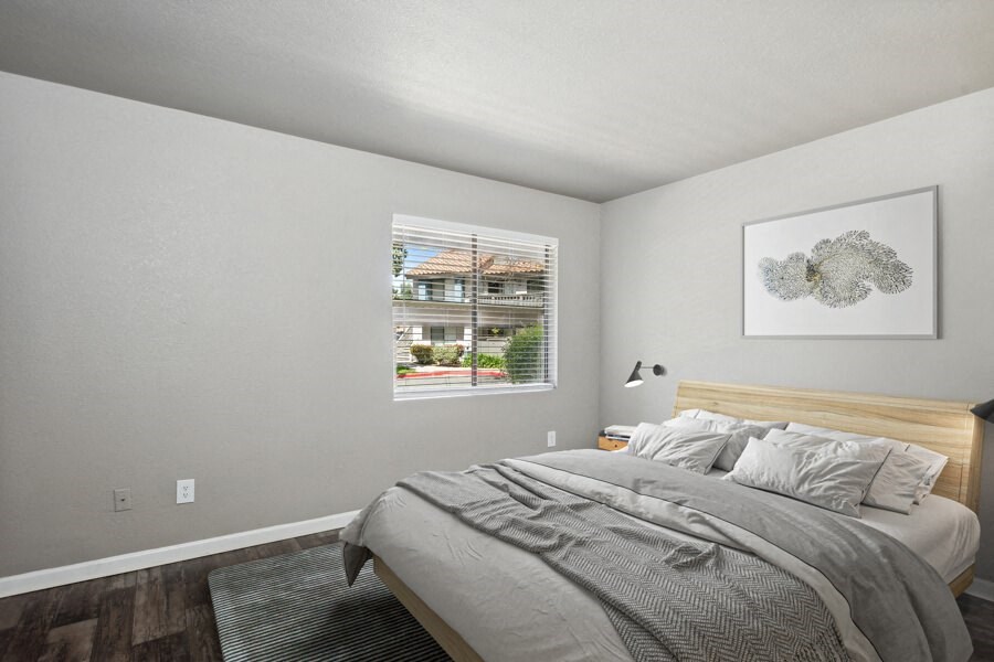 a bedroom with a bed and a window