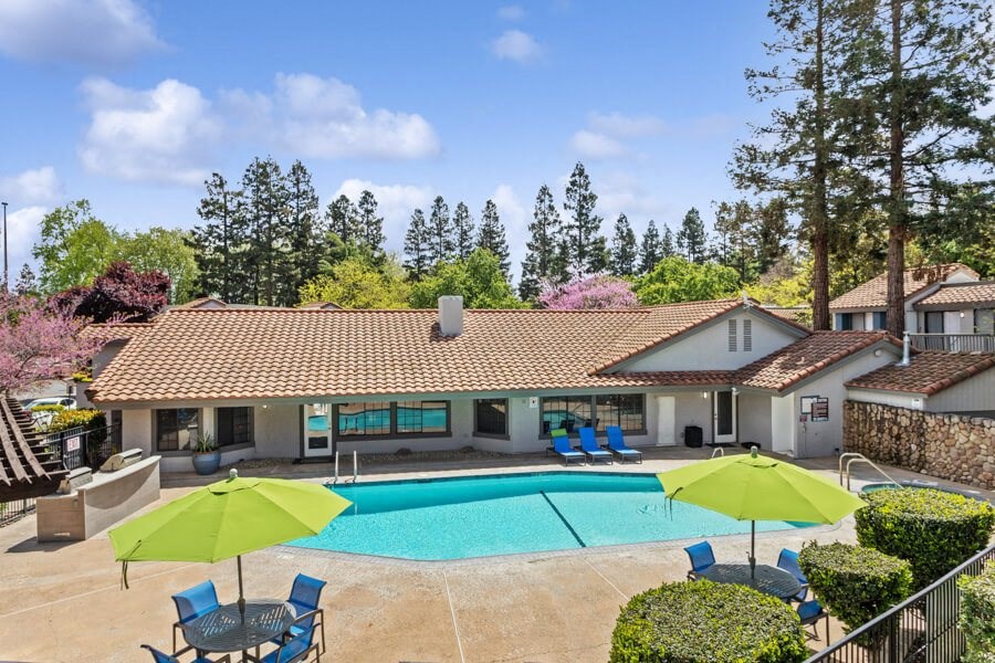 Clubhouse with a swimming pool in front of it