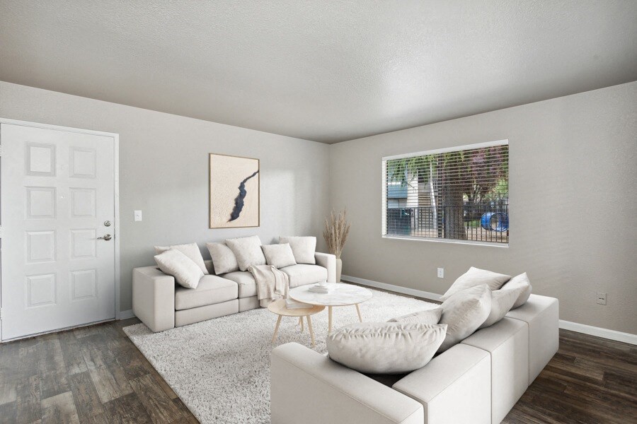 a living room with white couches and a coffee table