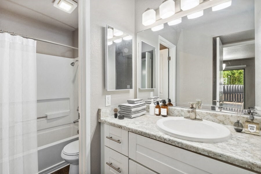 Model apartment bathroom with a sink and a toilet