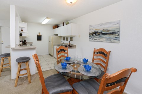 A dining room with a table set for two.