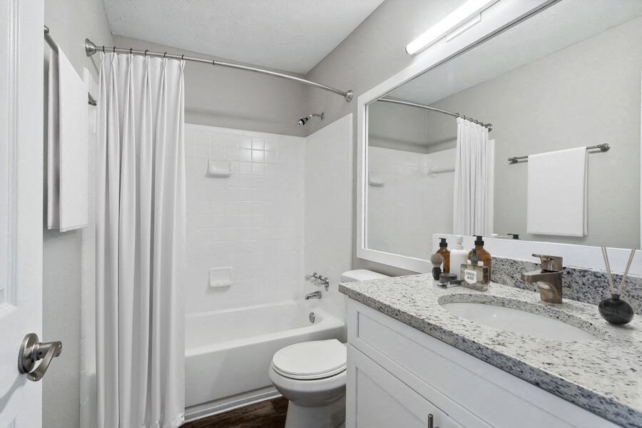 Model apartment bathroom with a sink toilet and a shower