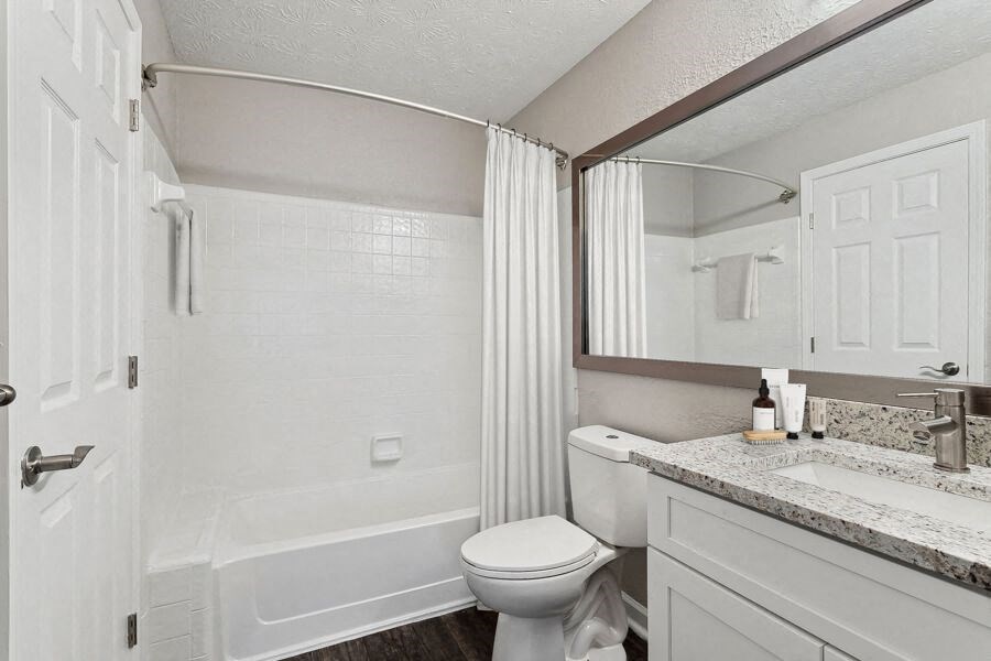Model apartment bathroom with a shower toilet and a sink