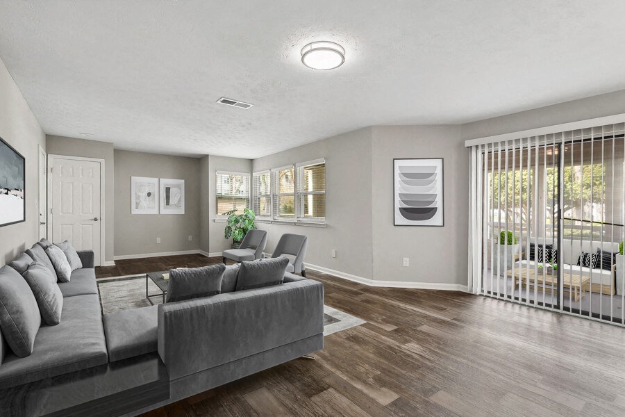 Model apartment living room is spacious and has a large sliding glass door to the patio