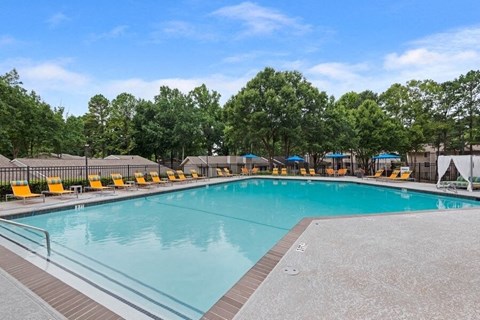 2-Bedroom Apartments in Norcross, GA - Elevate at Jackson Creek - Relaxing Outdoor Pool With Wide Sundeck, Lounge Chairs, and Umbrella Seating