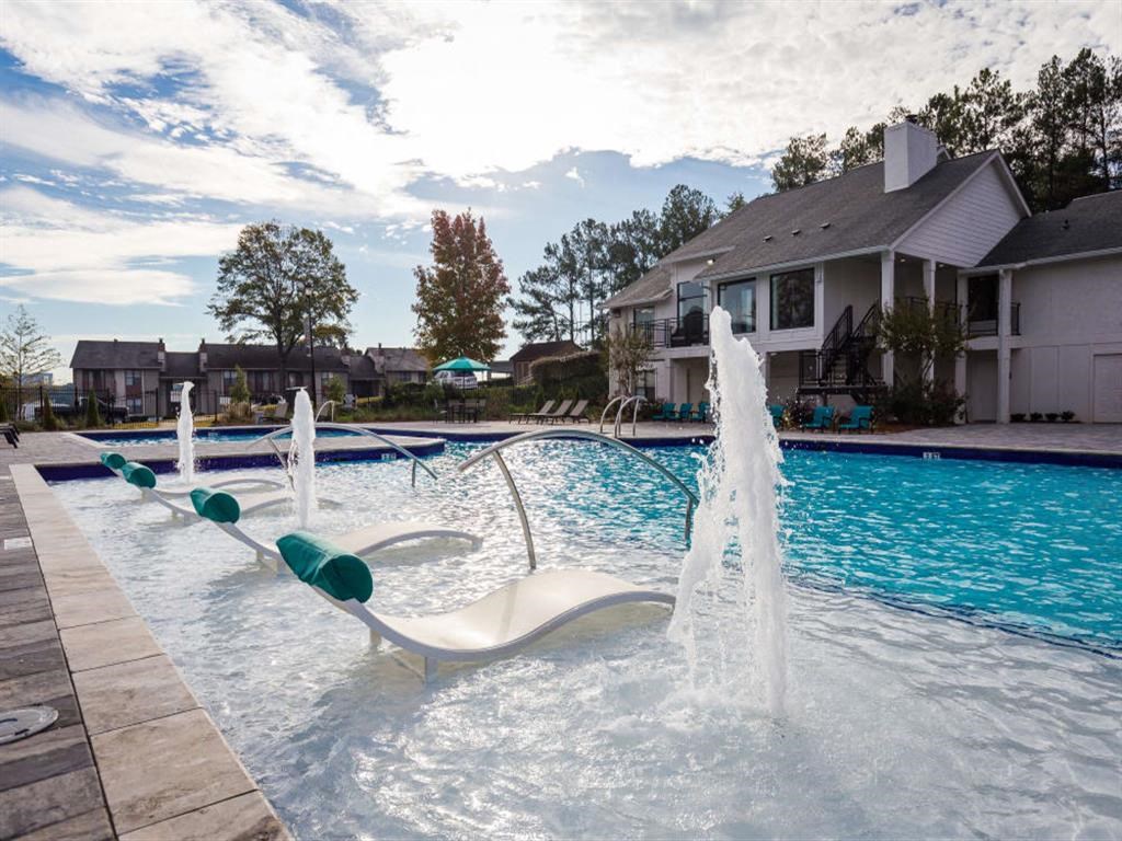 Swimming pool with cabanas and lounge chairs
