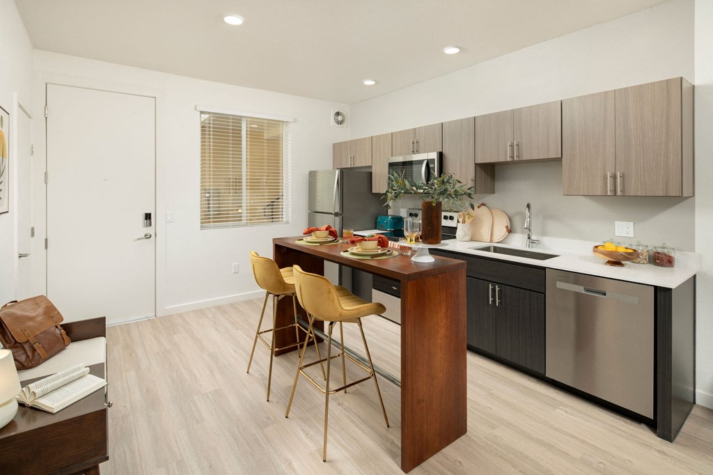 a kitchen with a large island with a breakfast bar