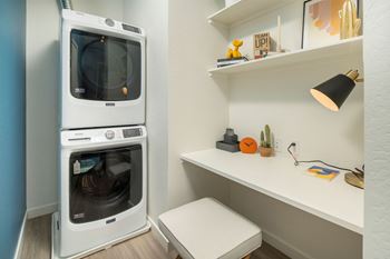 a washer and dryer are stacked on top of each other in a laundry room