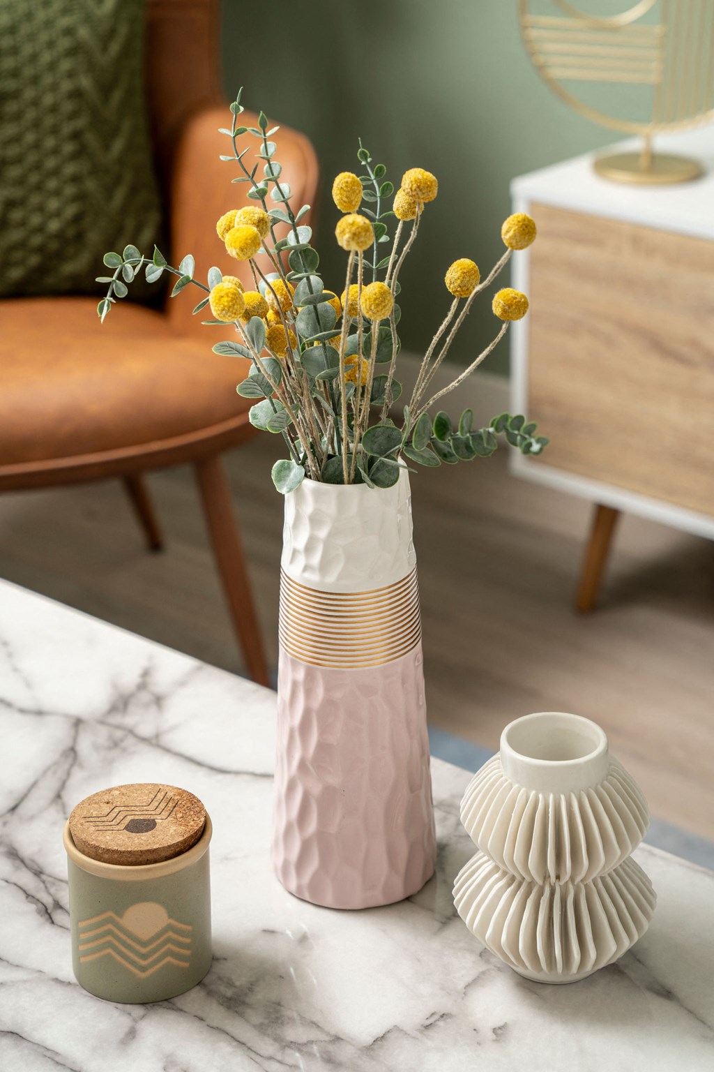 a vase with yellow flowers on a table