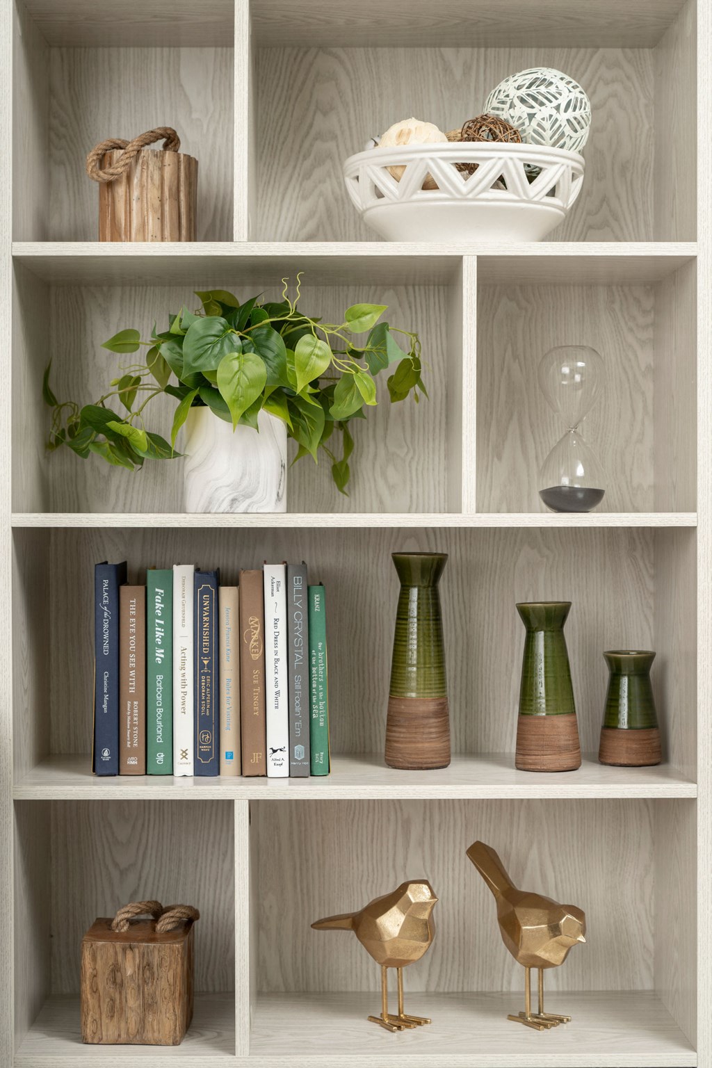 a bookcase with books and decorations on it