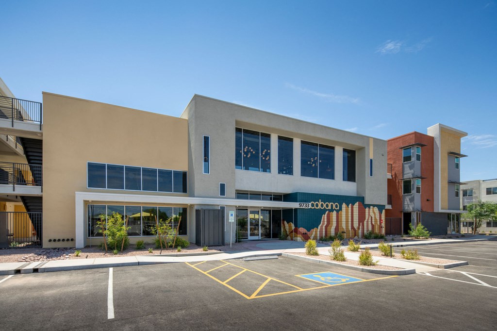 a large building with a parking lot in front of it