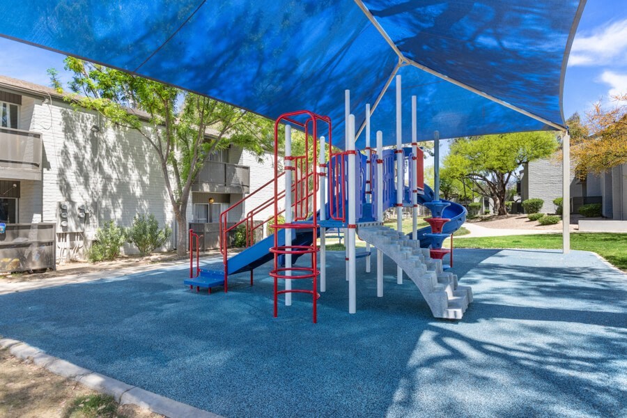 a playground with a blue and red slide