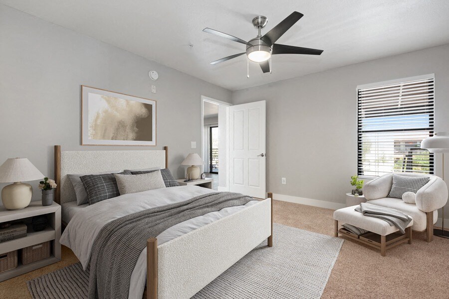Model apartment bedroom with a bed and a ceiling fan at Harmony at Surprise, Surprise, Arizona, 85379