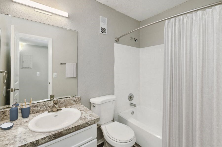 a bathroom with a sink toilet and bathtub