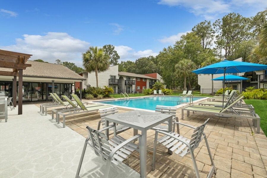 Sundeck with tables and a swimming pool